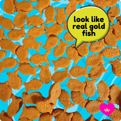 Owa Owa Gold Fishies treats scattered on teal background. Goldfish cracker-shaped healthy pet treats made with wild sockeye salmon, eggs, eggshell membrane, turmeric, and black pepper.