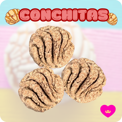 Close-up of Owa Owa Conchitas treats shaped like traditional Mexican conchas on a soft pink background.