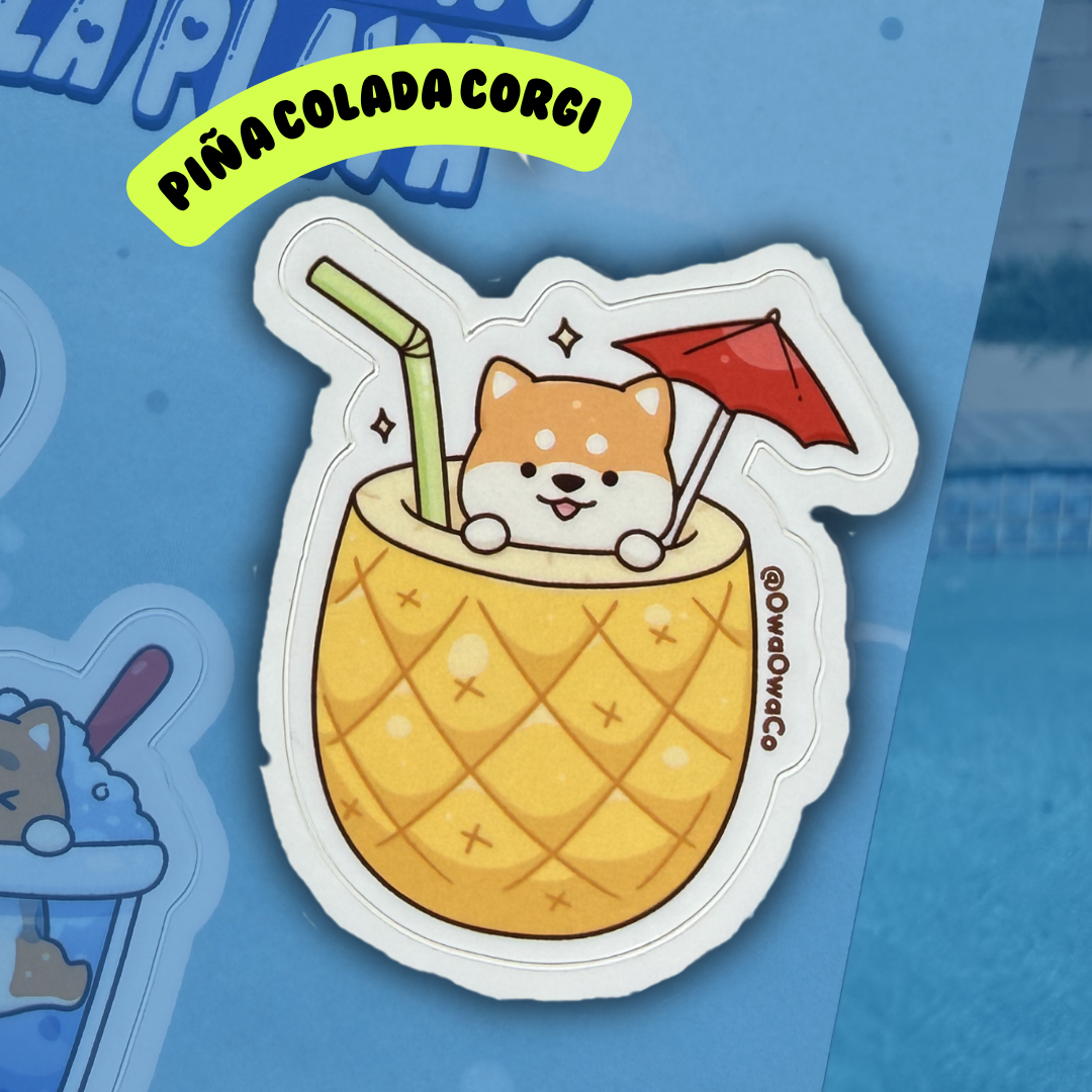 Owa Owa Treatlandia Sticker of a Corgi dog in a pina colada with a straw and umbrella on a blue background.
