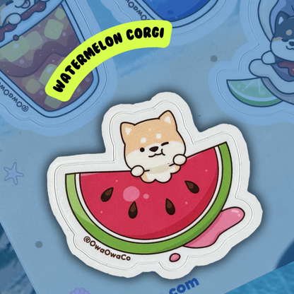 Owa Owa Treatlandia Sticker of a corgi on a watermelon slice with 'Watermelon Corgi' text above, on a blue background.