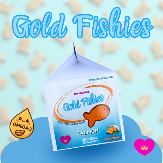 Owa Owa Gold Fishies carton on teal background with scattered goldfish-shaped treats. Made with wild sockeye salmon, eggs, eggshell membrane, turmeric, and black pepper for dogs and cats. 